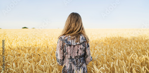 Fotografie Young woman in a wheat field