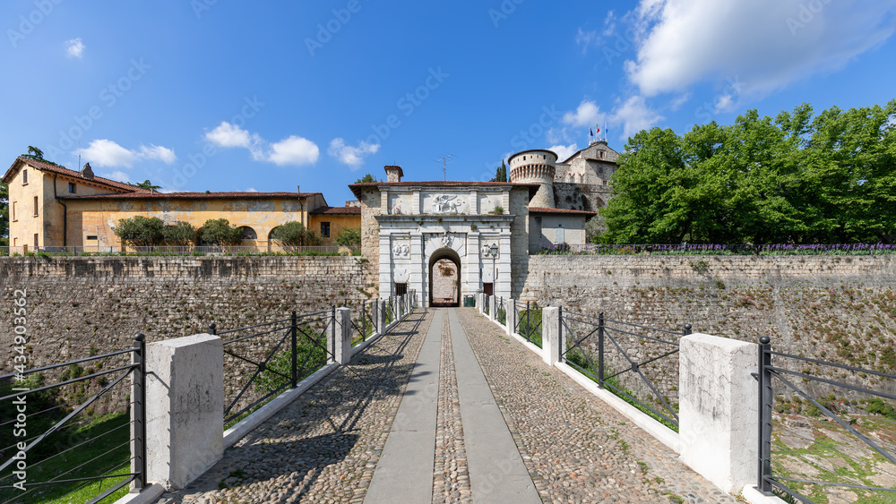 Panoramic view of the entire architectural ensemble of the main entrance to the historic castle of Brescia city.