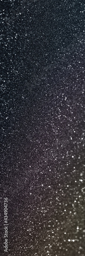 Black glitter bokeh circle glow blurred and blur abstract. Glittering shimmer bright luxury . White and silver glisten twinkle for texture wallpaper and background backdrop. 