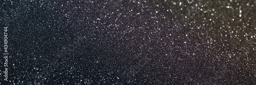 Black glitter bokeh circle glow blurred and blur abstract. Glittering shimmer bright luxury . White and silver glisten twinkle for texture wallpaper and background backdrop.
