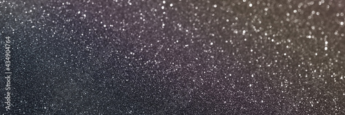 Black glitter bokeh circle glow blurred and blur abstract. Glittering shimmer bright luxury . White and silver glisten twinkle for texture wallpaper and background backdrop.
