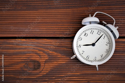 vintage alarm clock on wood background