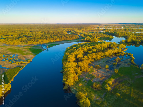 View from the drone on the beautiful nature landscape of the Dnieper River, green meadows, forest. European nature landscape. Landscape view of the river from above