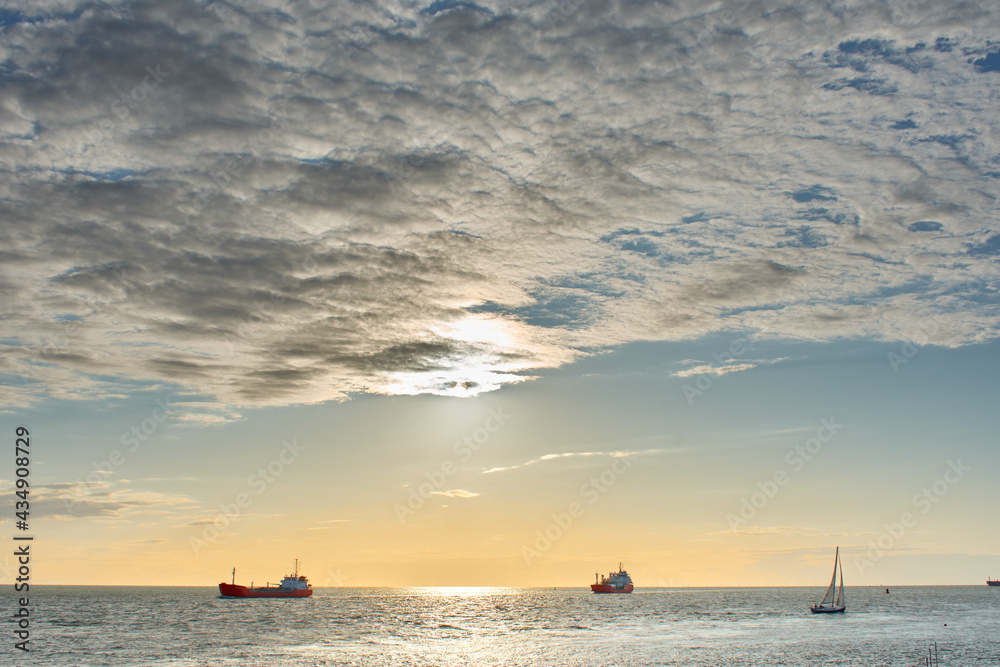 boats in the sea at sunset