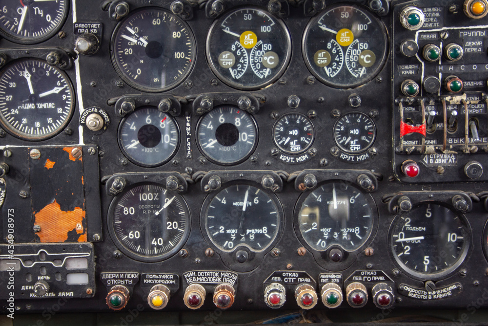 The dashboard of an old plane. Instruments and switches in the cockpit of an old plane The dashboard of an old plane. Instruments and switches in the cockpit of an old plane
