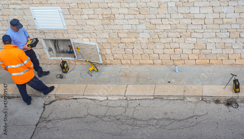 Surveyor with measuring wheel (odometer) detects the length of an excavation of minitrench