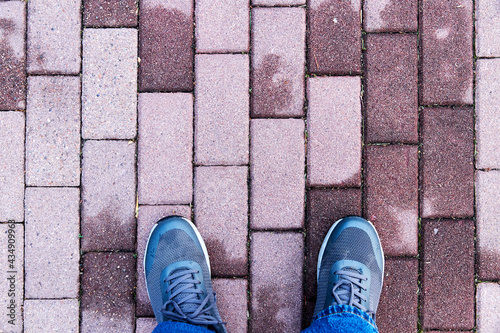 top view of feet on cobblestones path