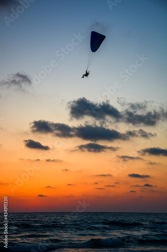 Paraglider in silhouette above the Mediterranean Sea near Haifa Israel 