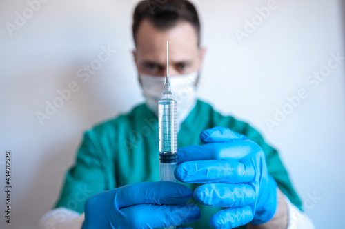 Nurse holding a syringe with a medicament inside