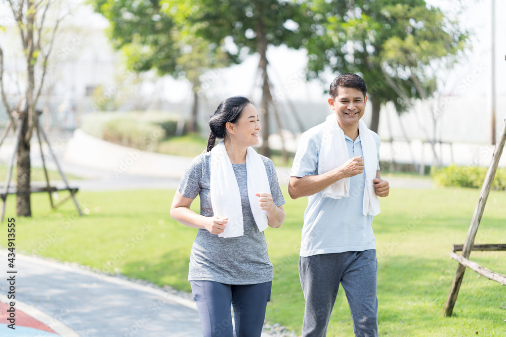 Obraz premium Happy couple of Asian people in summer sports outfit. Sporty mature couple staying fit with sport.