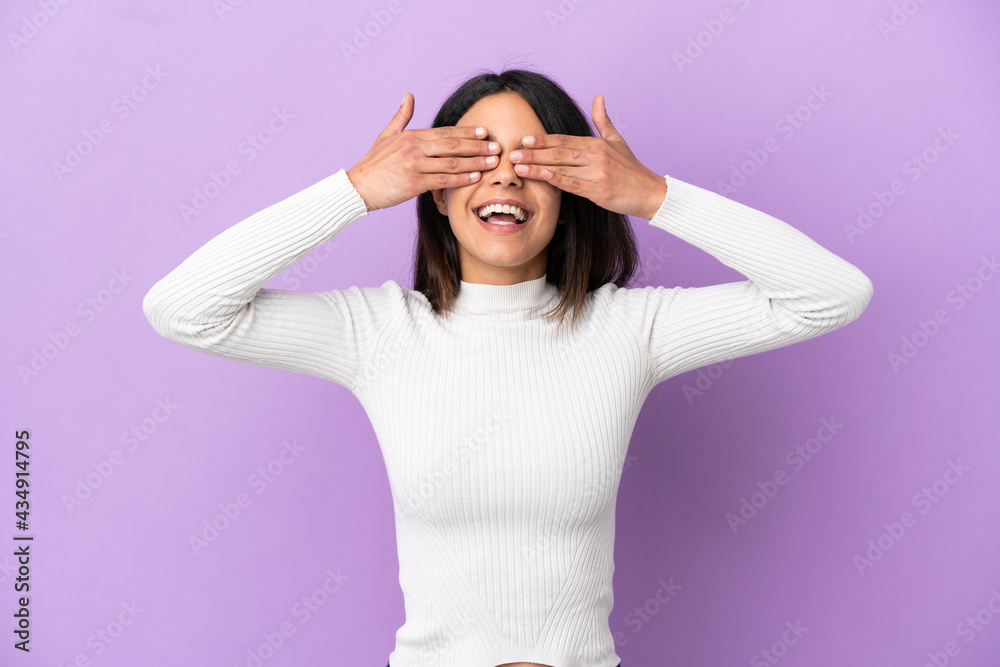 Young caucasian woman isolated on purple background covering eyes by hands and smiling Young caucasian woman isolated on purple background covering eyes by hands and smiling
