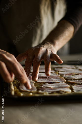 Male hands lays smoked bacon