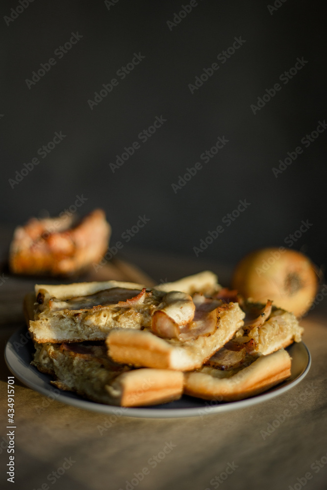Savory onion pie with bacon on a plate Savory onion pie with bacon on a plate