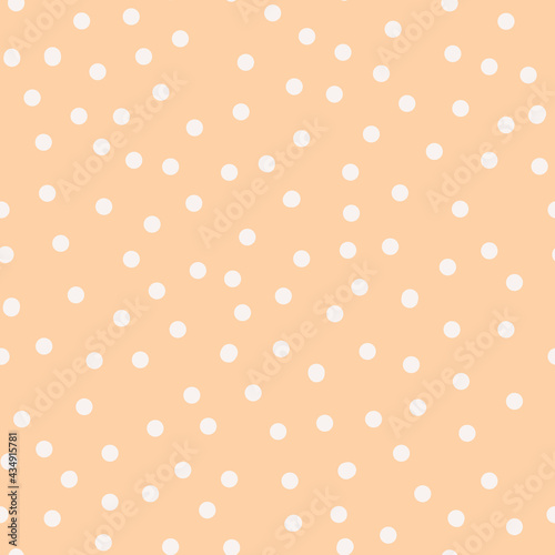 White irregular seamless polka dot pattern on peach background. Abstract retro texture with dots in boho style for designs, wrapping paper, covers and fabrics. Hippie vintage pattern in 70s style.