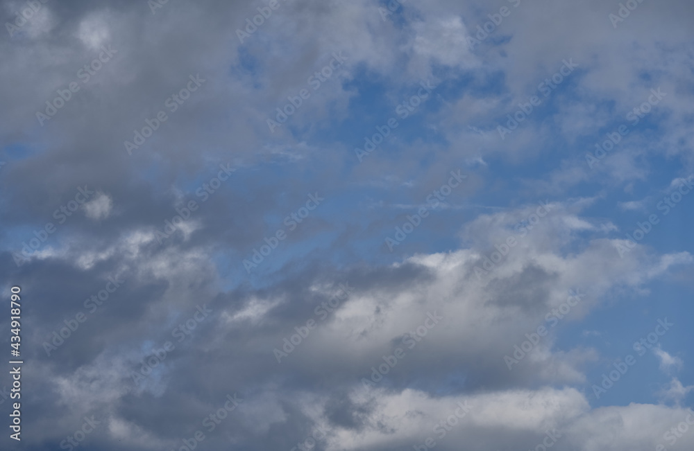 Dramatic thunderclouds float across the blue sky Dramatic thunderclouds float across the blue sky