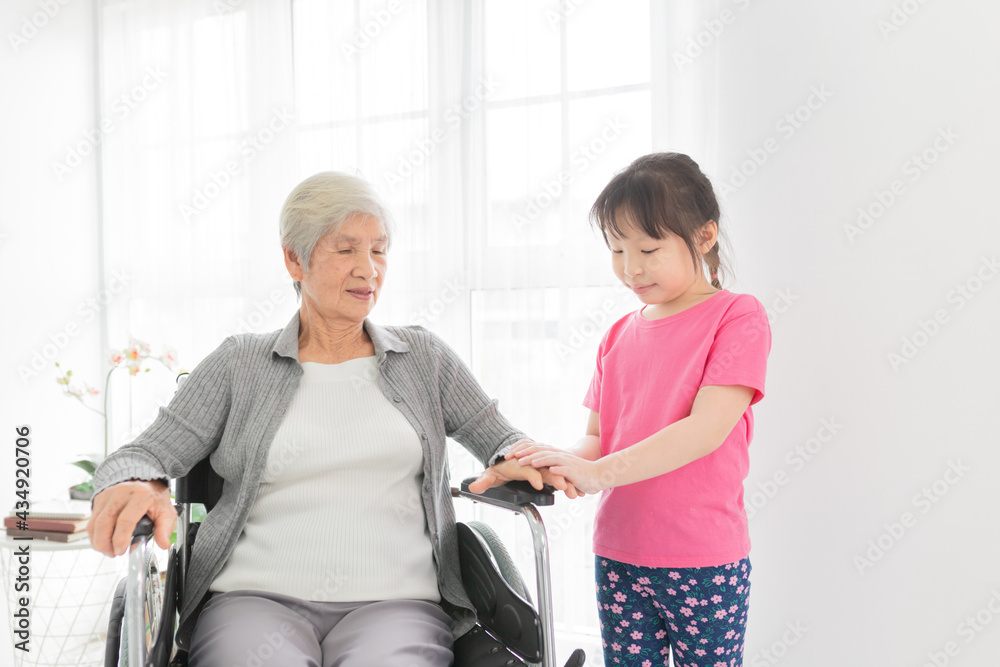 asian children holding hand of old woman, old patient sitting on wheelchair, happiness family time in mother's day, elderly rehabilitation activity asian children holding hand of old woman, old patient sitting on wheelchair, happiness family time in mother's day, elderly rehabilitation activity
