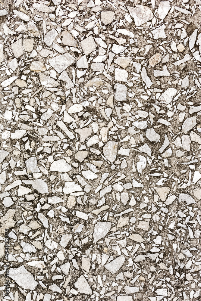Decorative plaster with small stones is applied to the wall. The pattern and texture of the stone. Decorative plaster with small stones is applied to the wall. The pattern and texture of the stone.