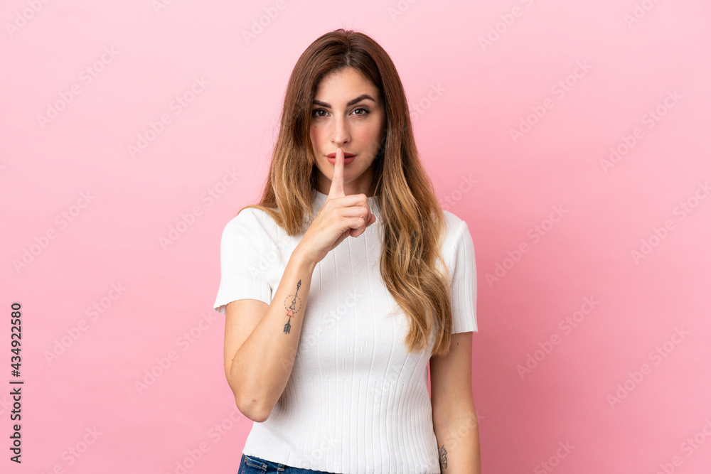 Caucasian woman isolated on pink background showing a sign of silence gesture putting finger in mouth Caucasian woman isolated on pink background showing a sign of silence gesture putting finger in mouth