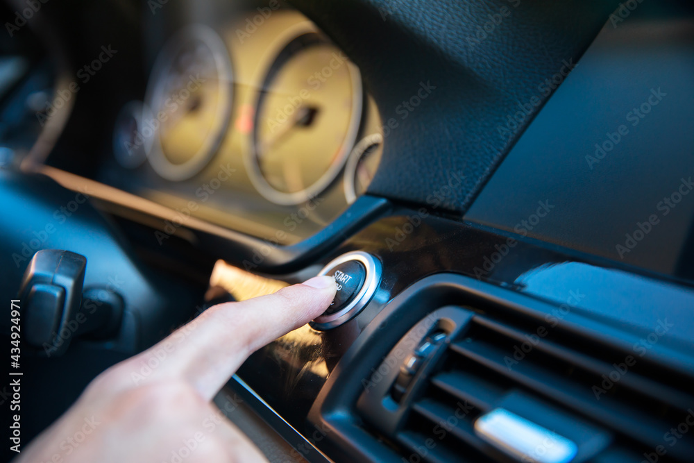 man finger presses the start stop button