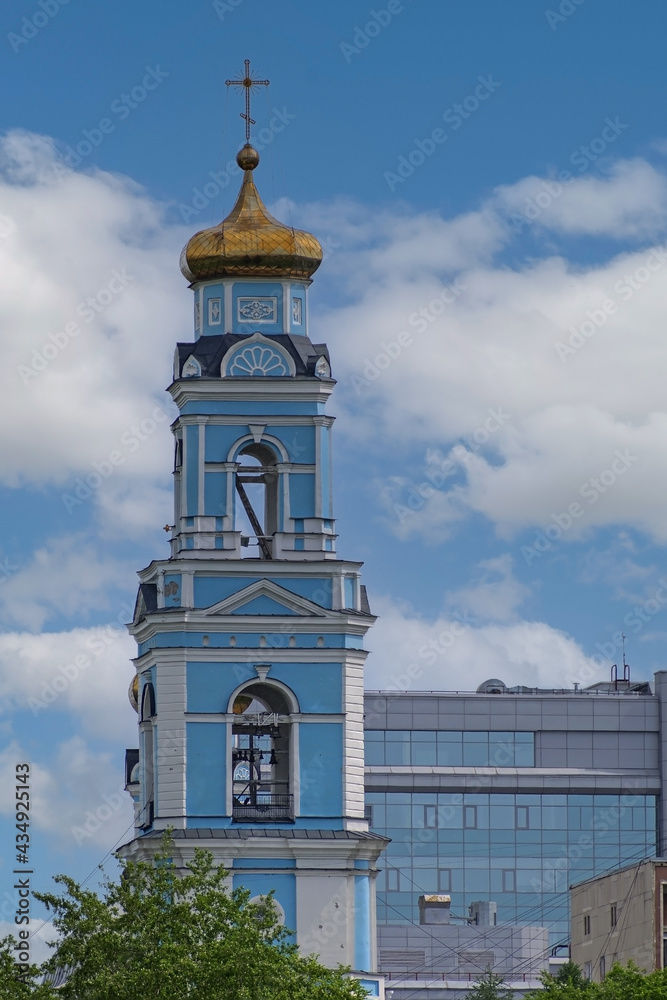 The upper part of the Orthodox church on the background of urban development