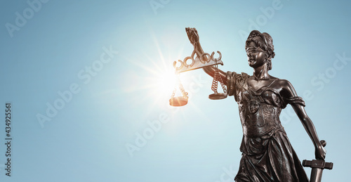 Lady justice, Themis sculpture over clear blue sky with copy space