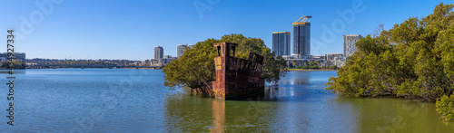 Rusted shipwreck in a mangrove area on Wentworth point Parramatta River NSW Australia 