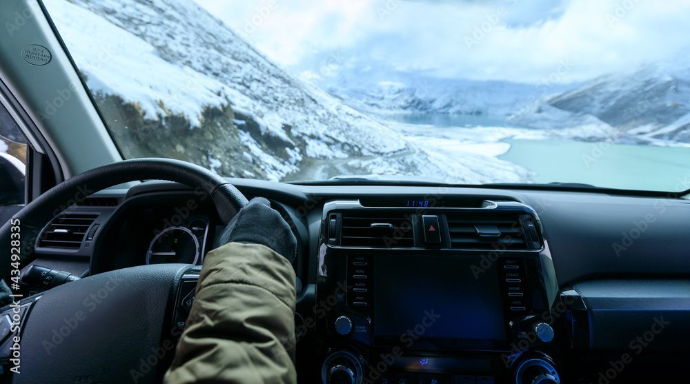 Driving off road car on snowing high altitude mountain trail on winter day Driving off road car on snowing high altitude mountain trail on winter day