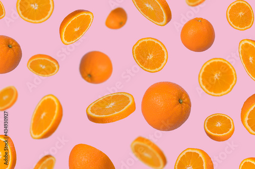 Fototapeta Naklejka Na Ścianę i Meble -  Minimal idea with fresh orange sliced on light pink background.