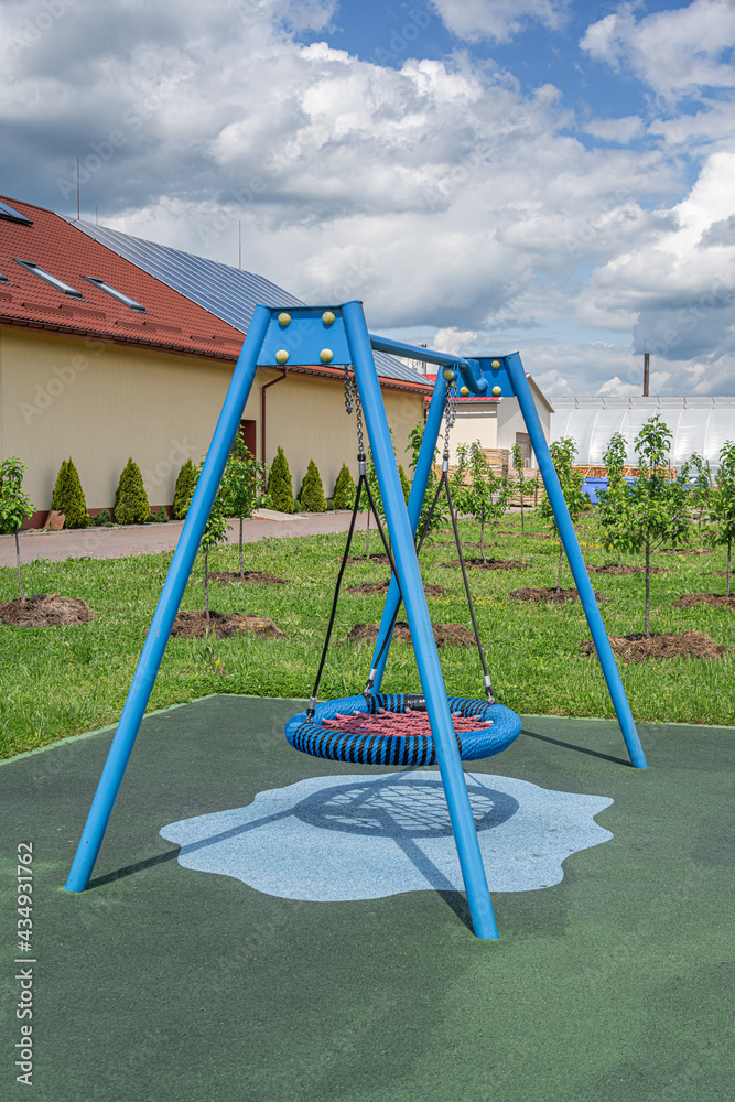 Children's swing in the open air. Playground for children's games. Children's swing in the open air. Playground for children's games.