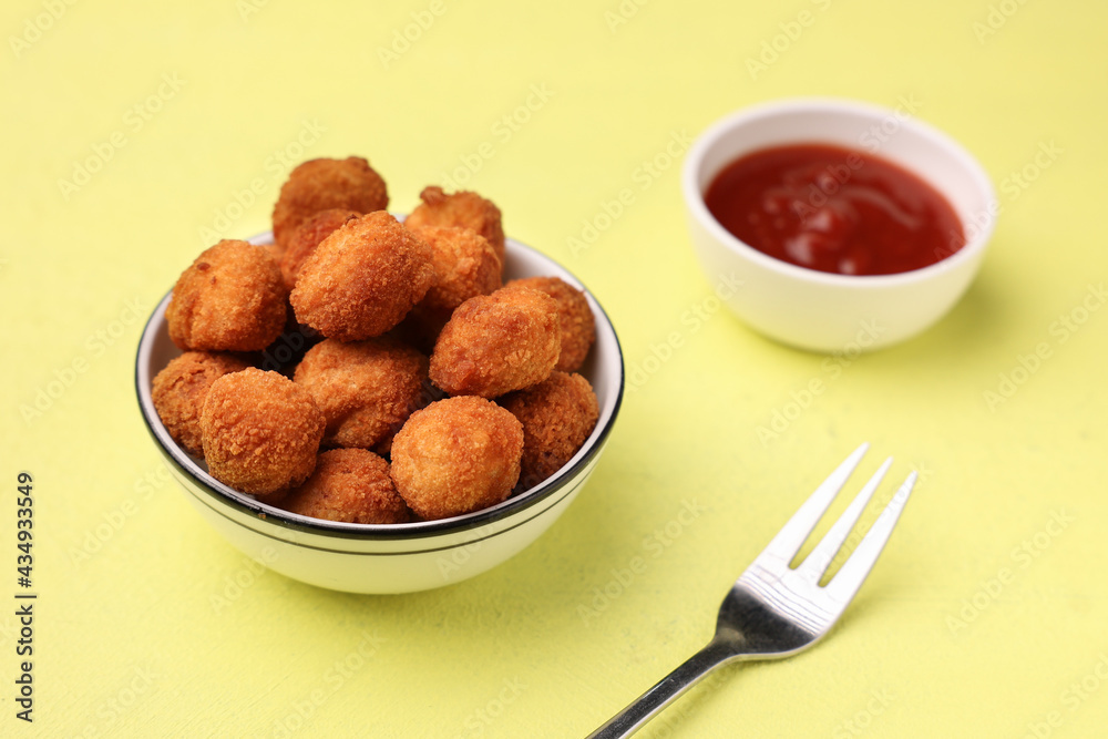 Crunchy chicken popcorn balls chicken nuggets bites for fast food meals with ketchup tomato sauce , fried snack appetizer lean meat balls kids favorite snack Crunchy chicken popcorn balls chicken nuggets bites for fast food meals with ketchup tomato sauce , fried snack appetizer lean meat balls kids favorite snack