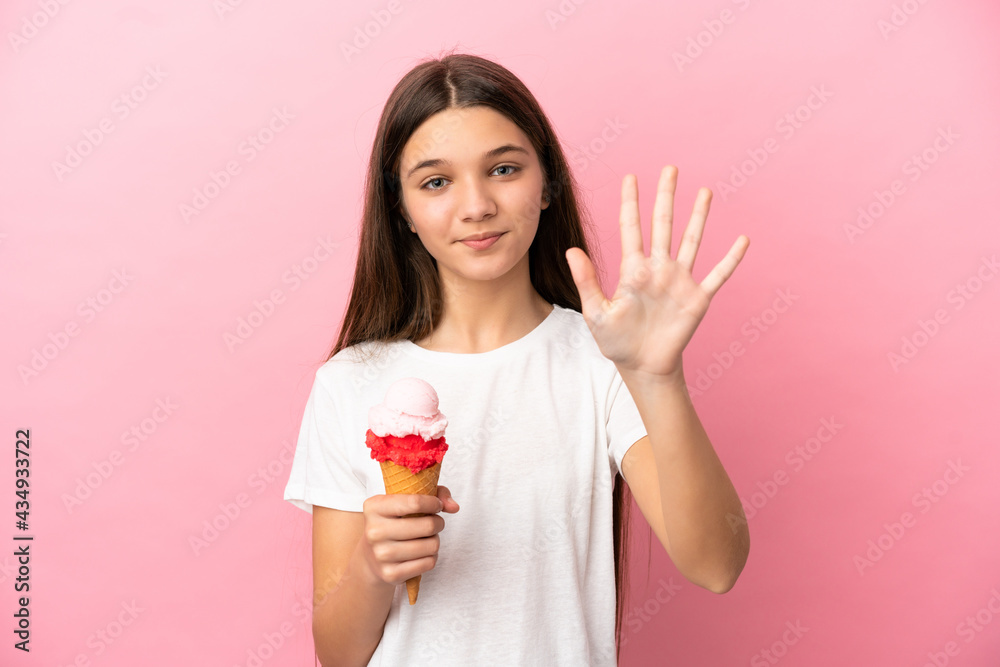 Little girl with a cornet ice cream over isolated pink background counting five with fingers Little girl with a cornet ice cream over isolated pink background counting five with fingers