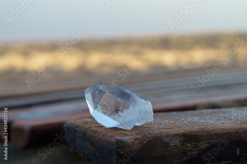 crystal quartz on beach background