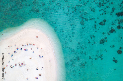 Aerial view or top view of beautiful curve beach with traveller relaxing with the emerald sea at Koh Lipe island in Satun, Thailand. Space for text. - Image photo