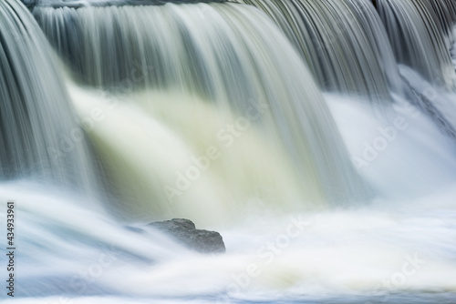 Landscape captured with blurred motion of a cascade on the Rabbit River  Michigan  USA