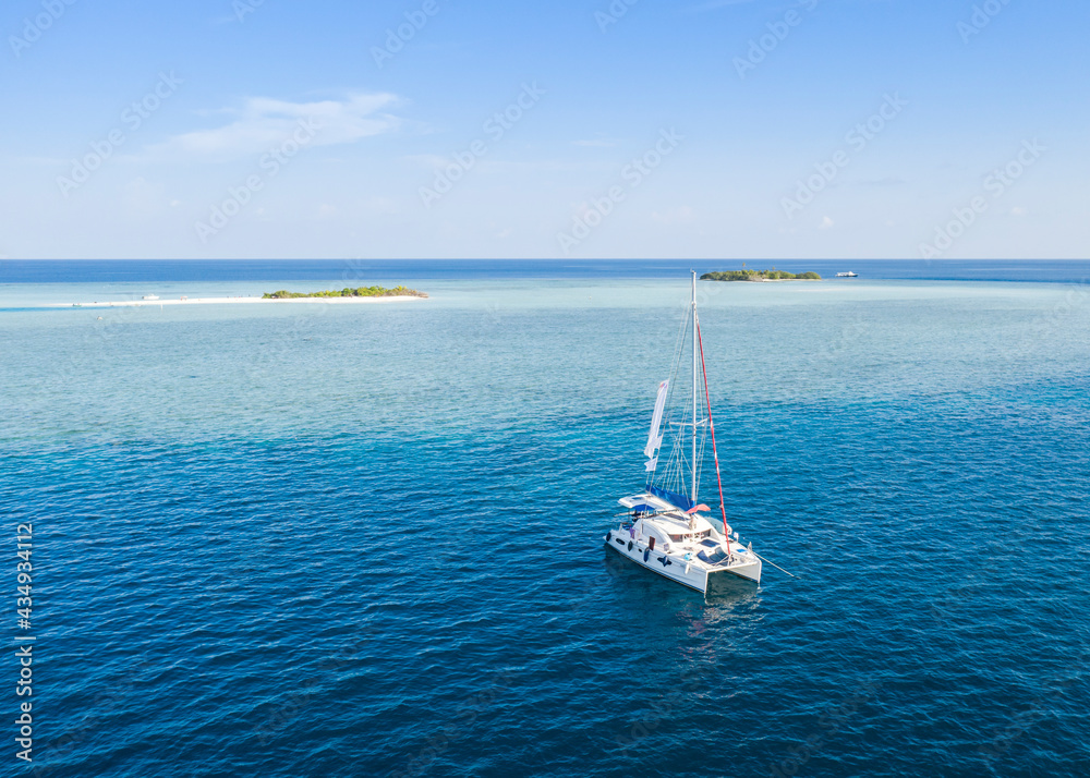 Catamaran near the Maldivian islands in the Indian Ocean Catamaran near the Maldivian islands in the Indian Ocean