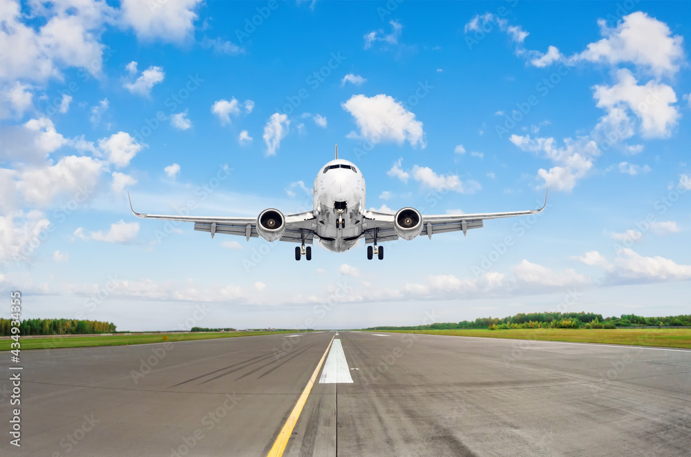 Airplane take off in runway against the background of clouds and blue sky. Airplane take off in runway against the background of clouds and blue sky.