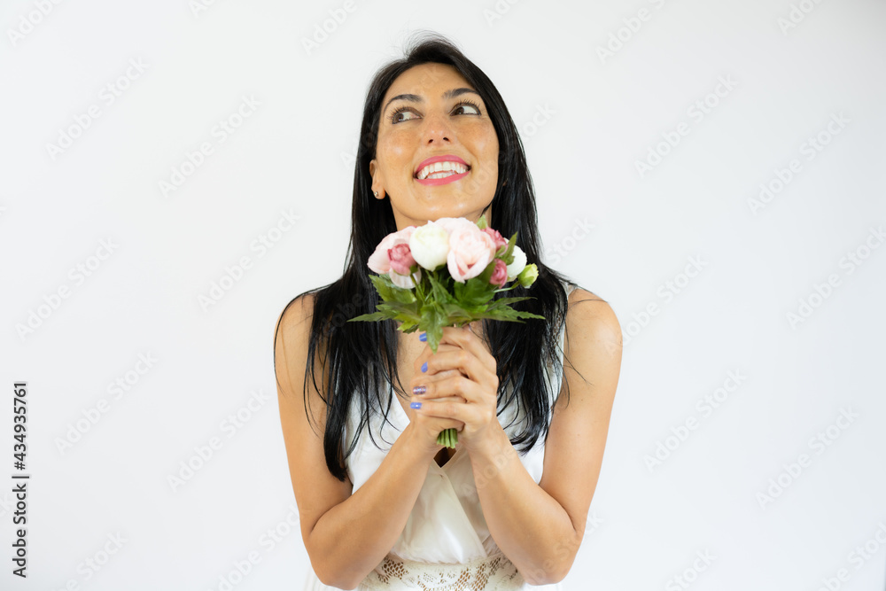 Beautiful smiling woman holding bouquet of flowers over white background Beautiful smiling woman holding bouquet of flowers over white background