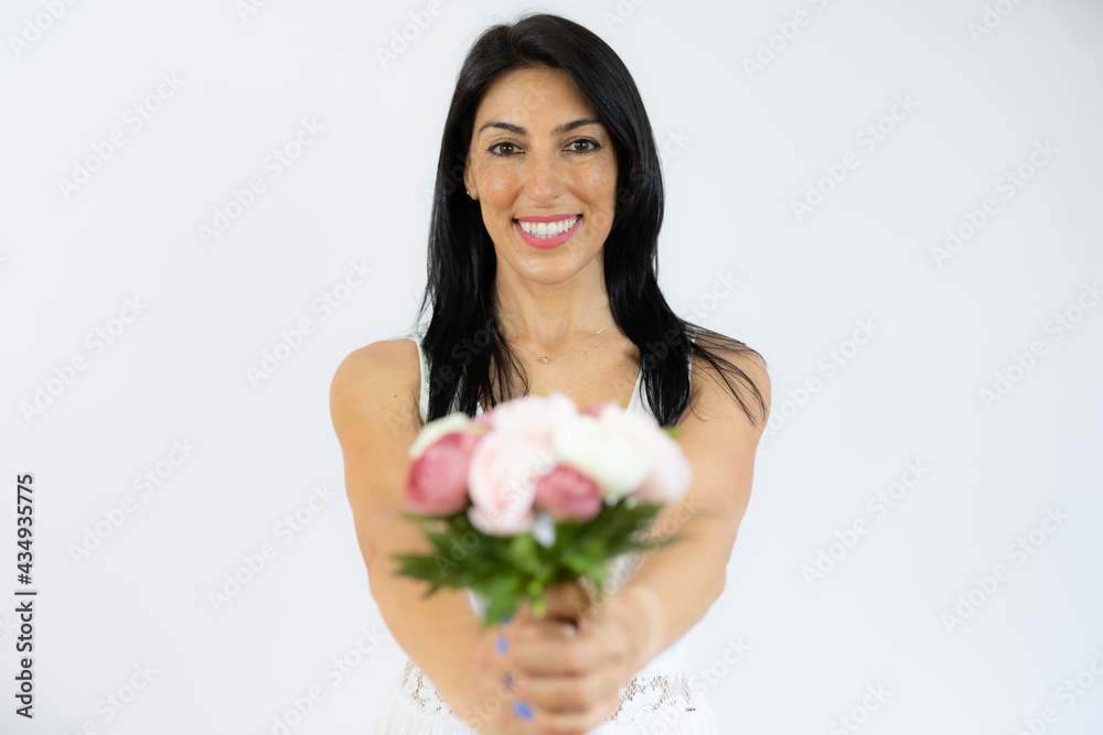 Beautiful smiling woman holding bouquet of flowers over white background Beautiful smiling woman holding bouquet of flowers over white background