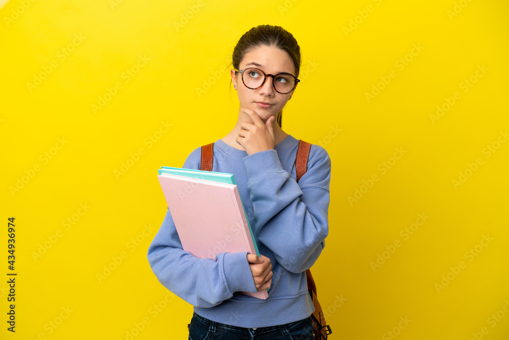 Student kid woman over isolated yellow background having doubts Student kid woman over isolated yellow background having doubts