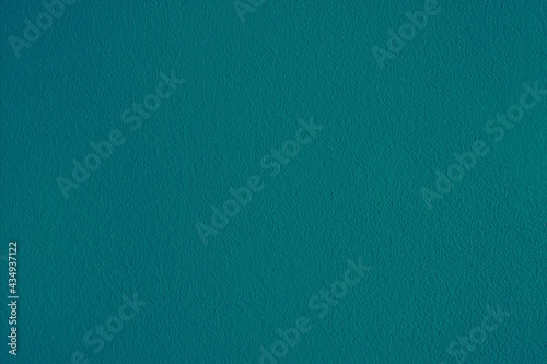 Blue green textured background surface.  Horizontal dark teal backdrop.  Plain cyan blank template, plain wallpaper, copy space.