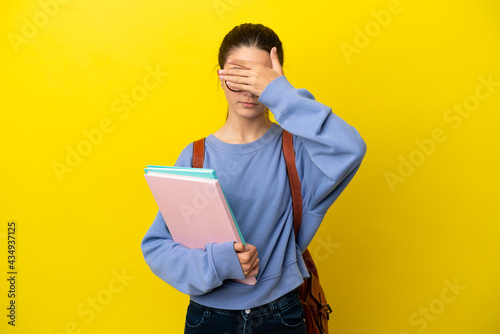 Student kid woman over isolated yellow background covering eyes by hands. Do not want to see something