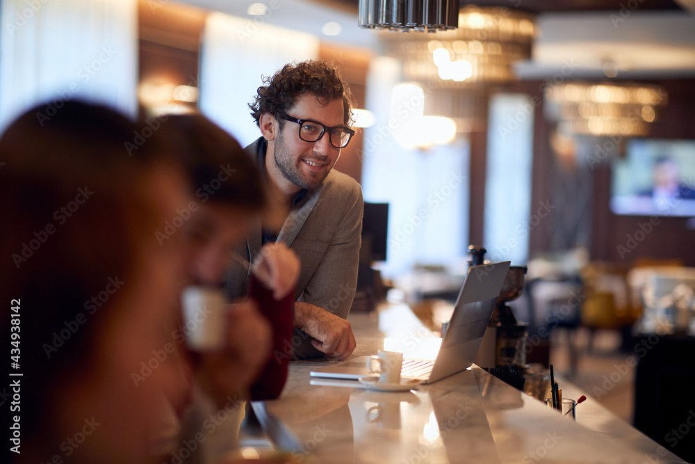 young handsome businessman working from a bar, drinking coffee - obrazy, fototapety, plakaty 