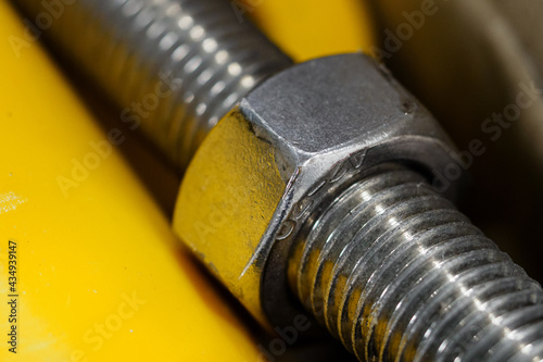 Photography Large metal nut on the threaded rod.