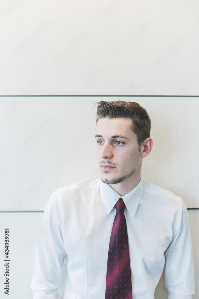 Young businessman indoor posing looking over pensive Young businessman indoor posing looking over pensive