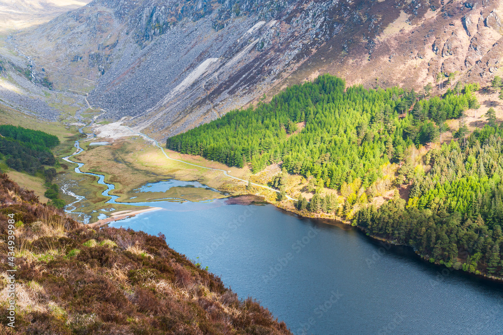 View from above over Glendalough Upper Lake in Wicklow National Park, Ireland. Irish mountains scenery as seen from the Spinc trail, a popular hiking path.