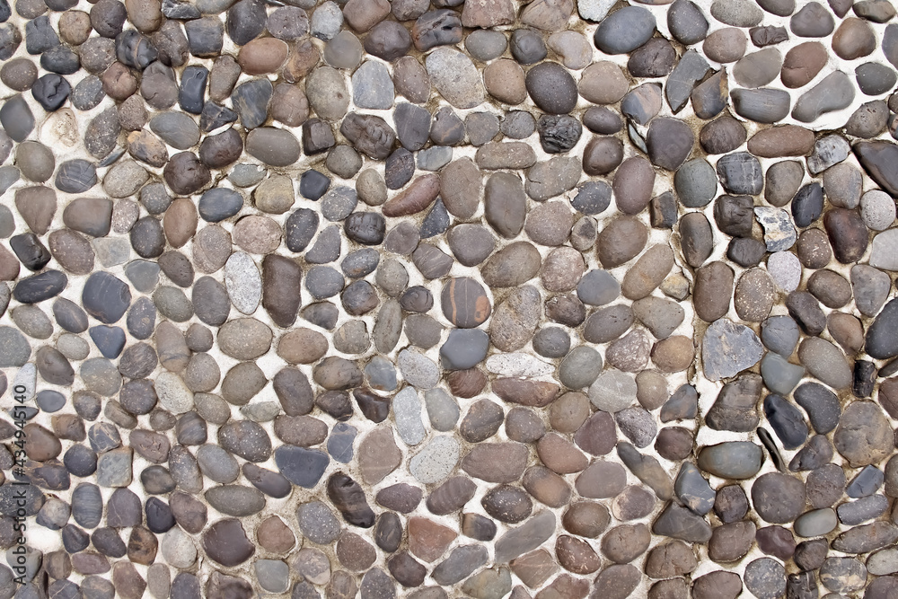 Decorative small stone texture on concrete wall brown floor old background Decorative small stone texture on concrete wall brown floor old background