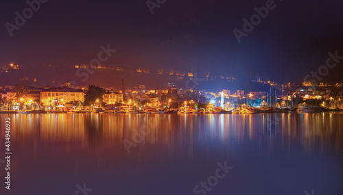 Resort town of Fethiye city lights reflection on the water with lot of boat - Fethiye, Turkey