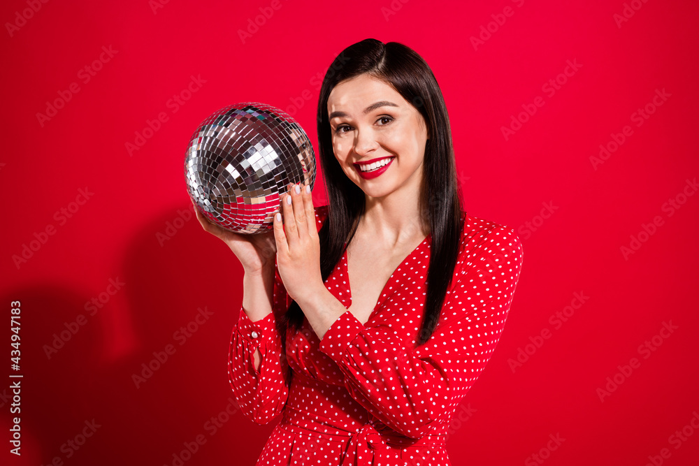Obraz premium Photo of impressed brunette lady hold ball wear red dress isolated on vivid color background