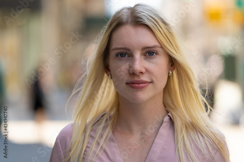 Young caucasian woman in city serious face portrait