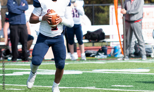 Football quarterback about to make a pass during a high school game